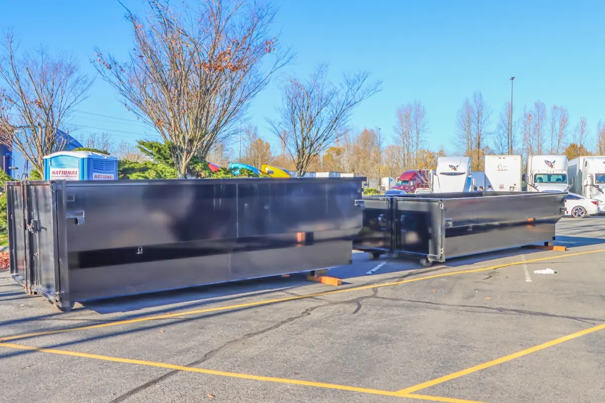 Professional dumpster rental service with roll-off container on residential driveway in Casper